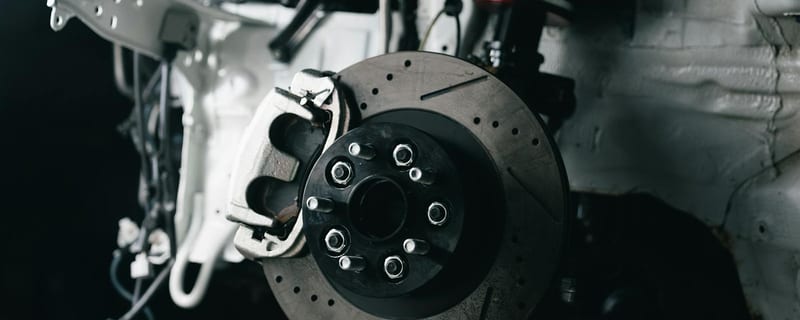 Car brake disc and caliper during brake servicing