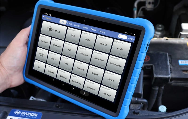Launch diagnostic tablet running a vehicle fault scan in an engine bay